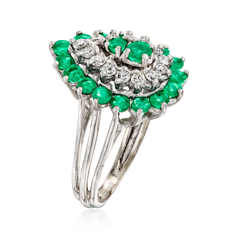 Emerald and diamond cluster ring with white gold split shank, side view of prongs and green gems