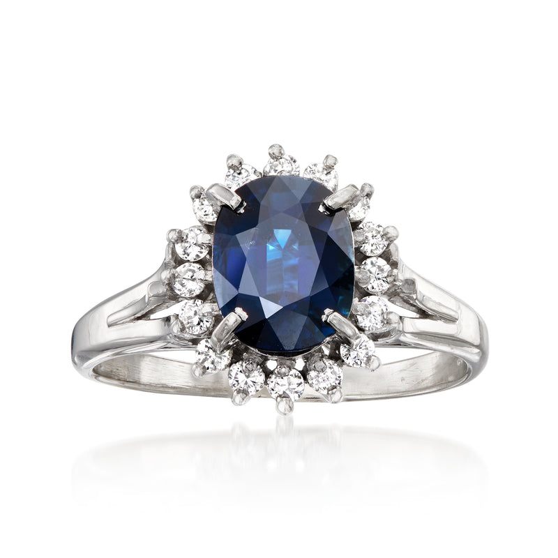 Platinum ring with cushion-cut sapphire and diamond halo, small round diamond accents