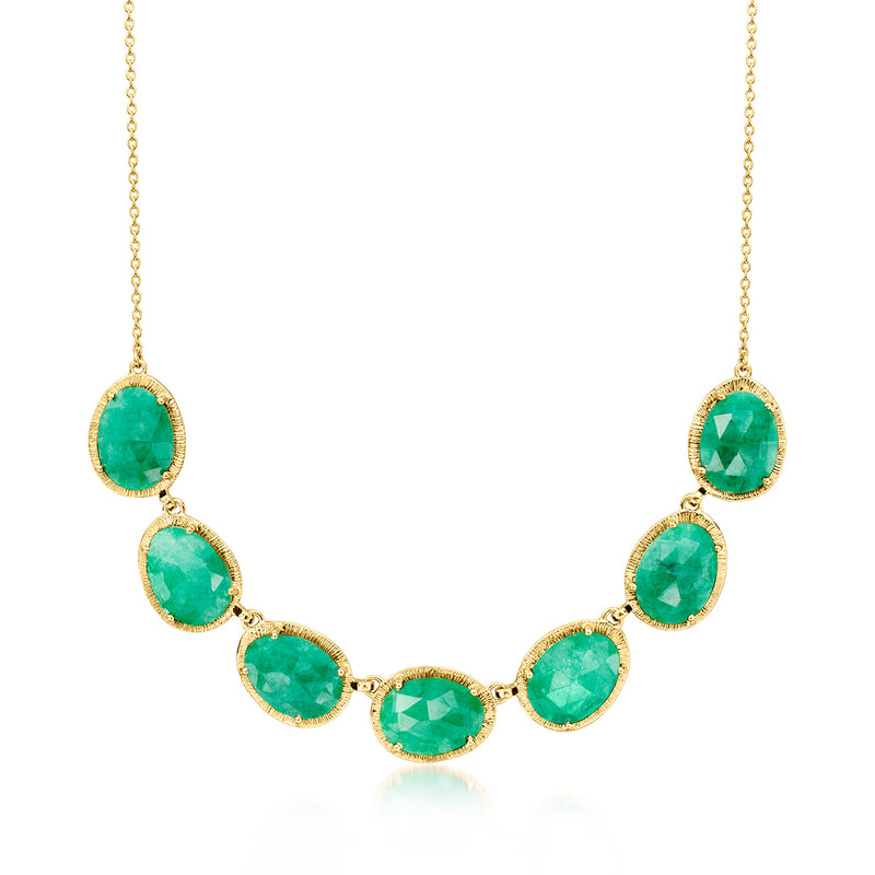 Gold-tone necklace with oval emerald-green gemstones in bezel settings
