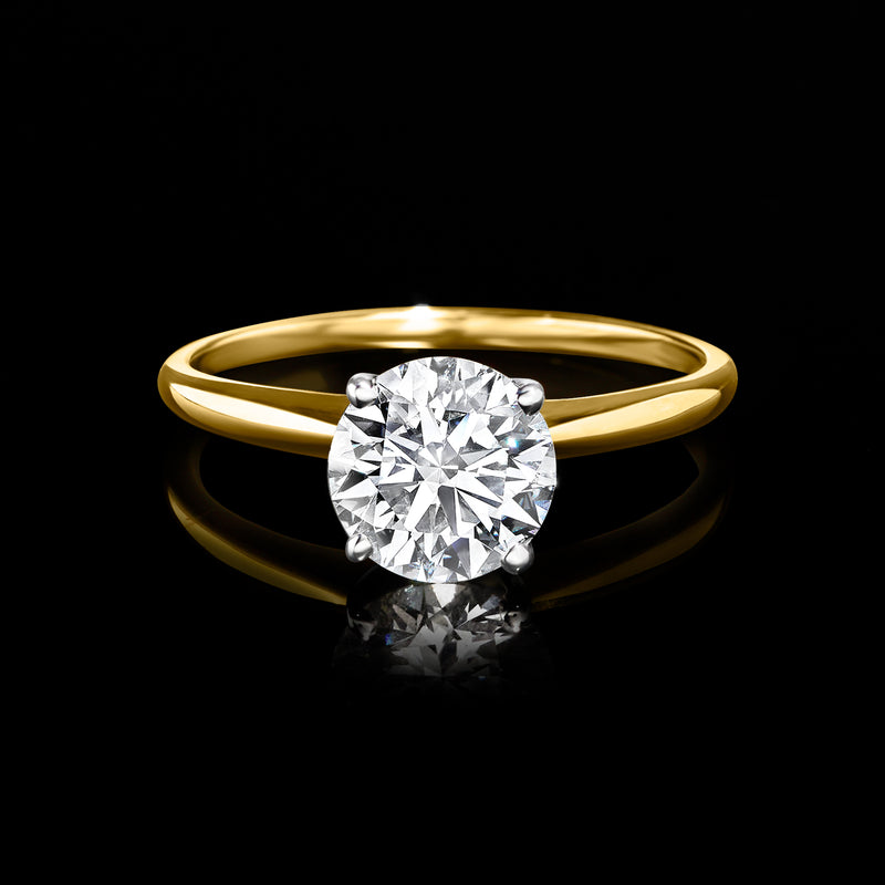 14kt yellow gold solitaire ring with round diamond center and smooth polished band