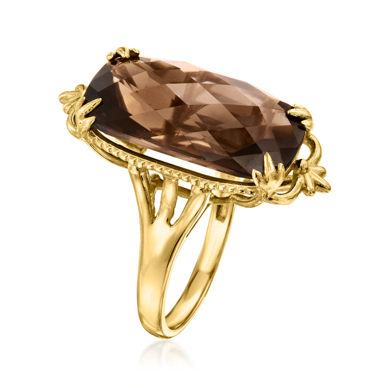 Gold-tone ring with large oval smoky quartz gemstone and decorative halo prongs