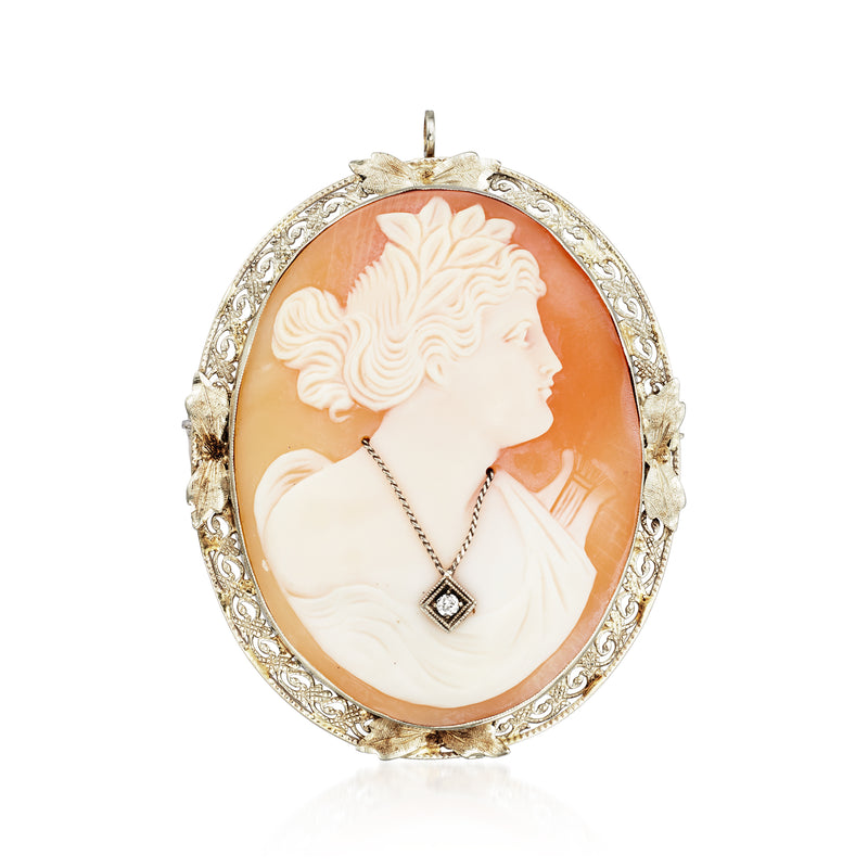 Oval vintage cameo pendant pin in brown shell with white profile, diamond, ornate white-gold frame