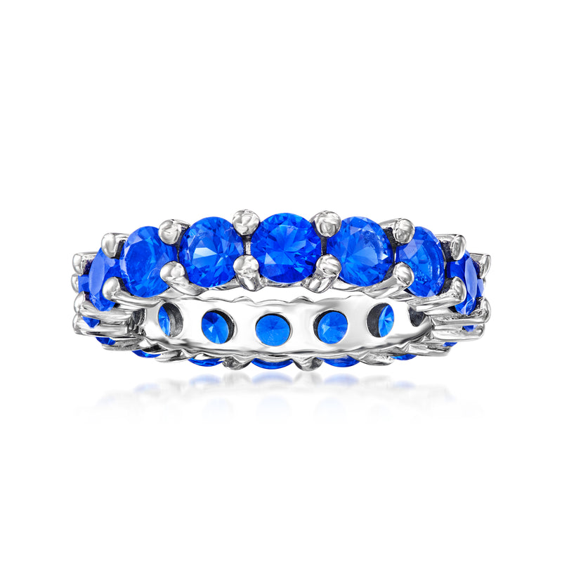 Sterling silver eternity band with round blue simulated sapphire-style stones