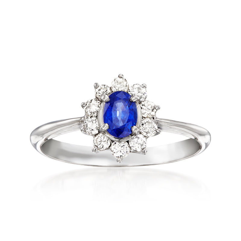 Platinum vintage ring with oval blue sapphire and diamond halo with side diamonds