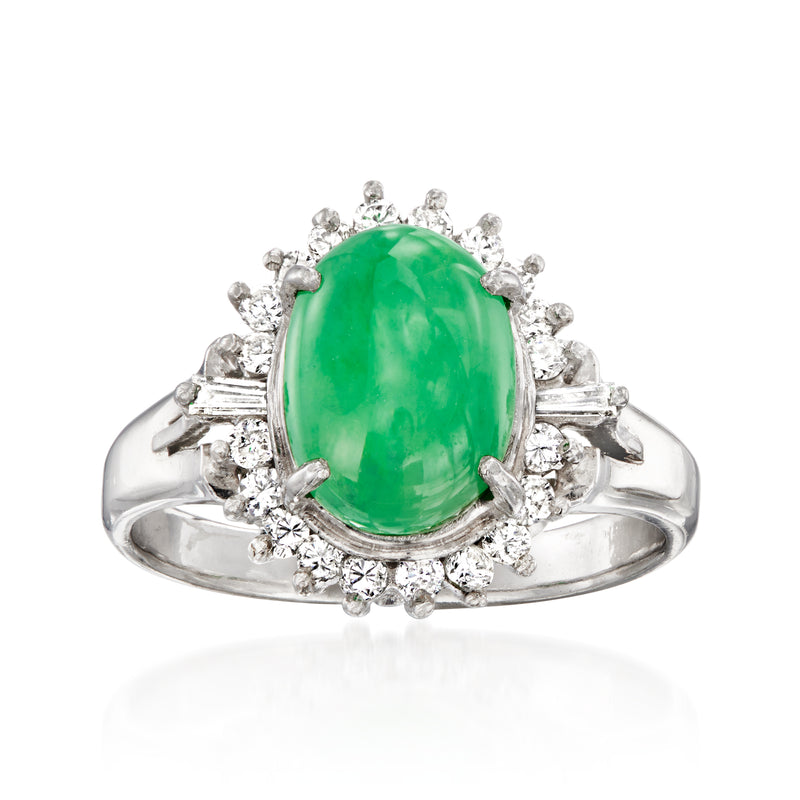 Platinum ring with oval green jade, diamond halo, and baguette accents
