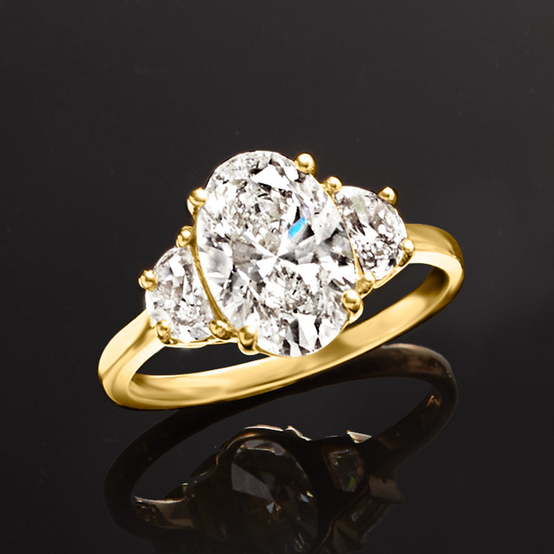 Yellow gold diamond ring, close view of oval center stone and side diamonds