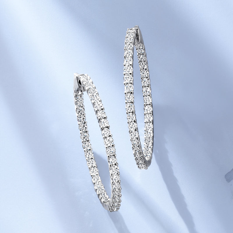 Inside-out diamond hoop earrings with shimmering pave on white gold, close-up