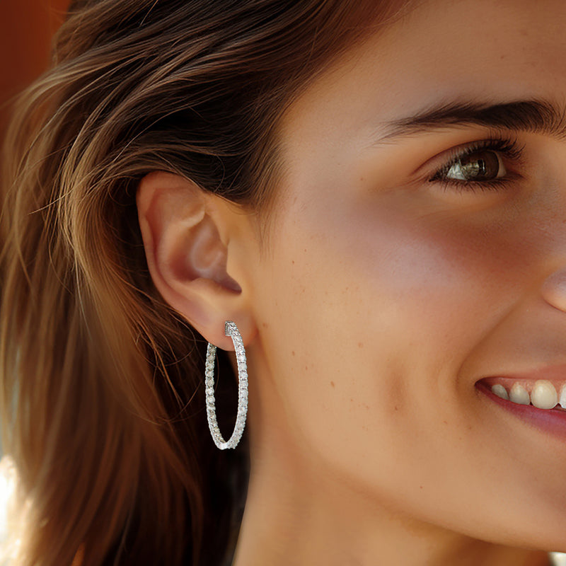 Diamond inside-out hoop earrings in 14kt white gold, worn on ear, close-up