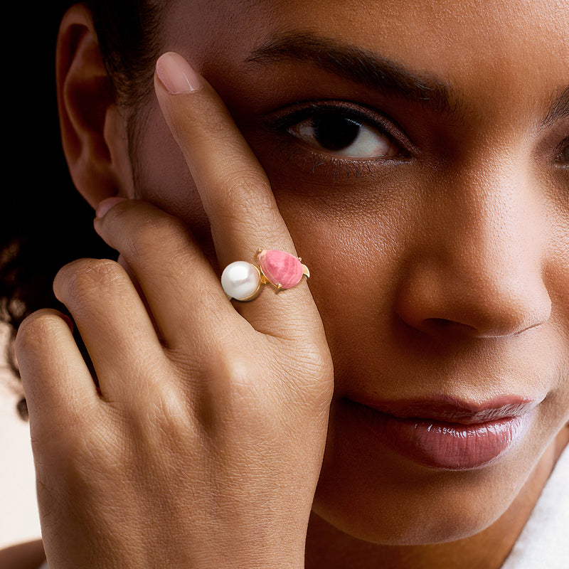 Toi et moi ring on hand: white cultured pearl with pink stone in gold-tone setting