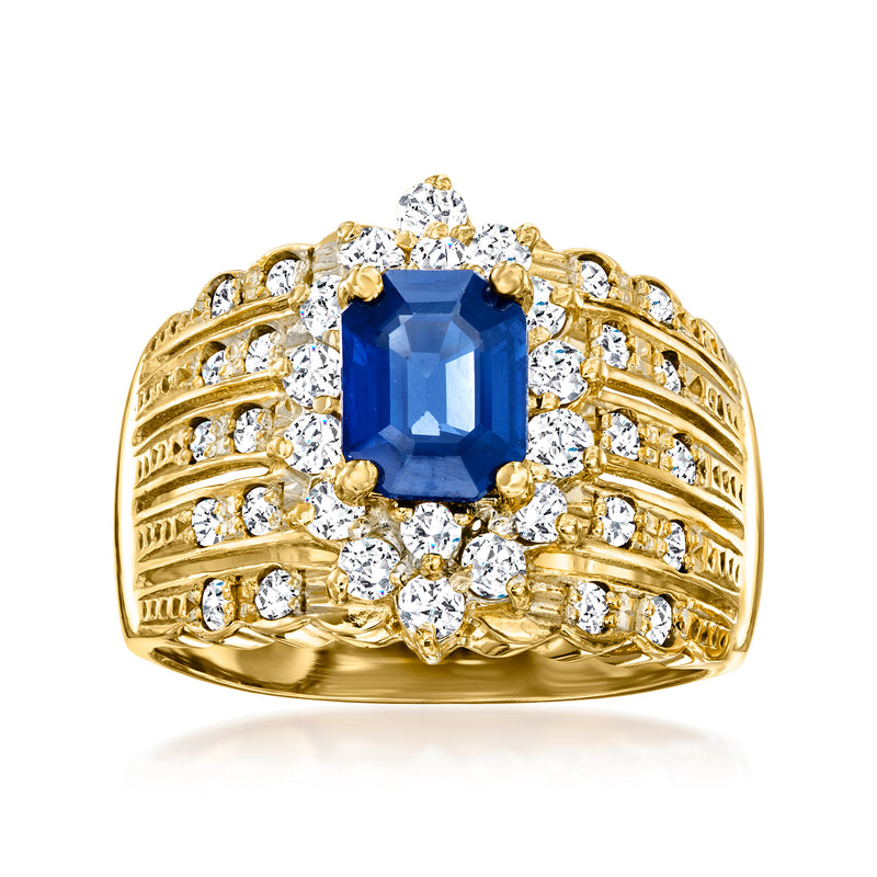 18kt yellow gold ring with blue sapphire center and diamond halo and side stones