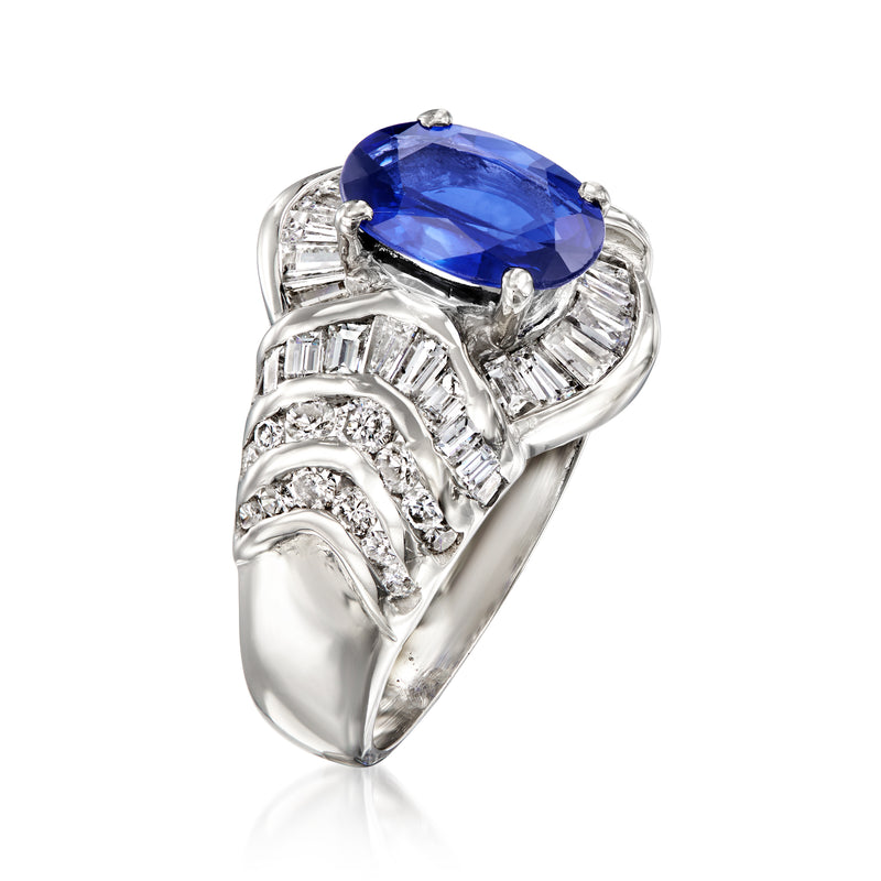 Platinum ring with oval blue center stone and diamond baguette halo accents