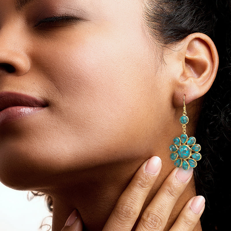 Turquoise flower drop earrings on ear with gold hooks, long dangling cluster