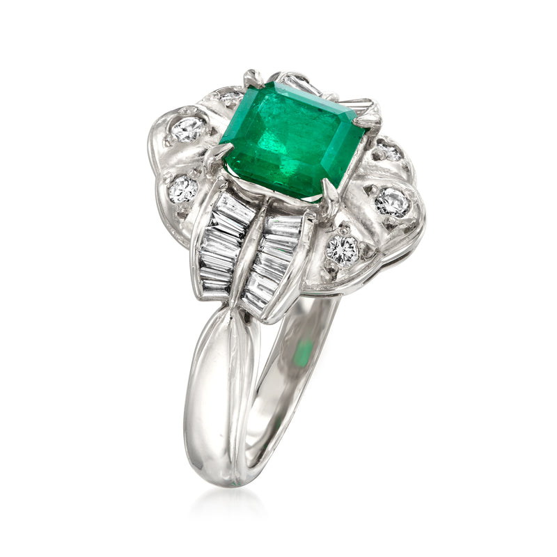 Platinum ring with emerald-cut green emerald, diamond baguettes on side and prongs