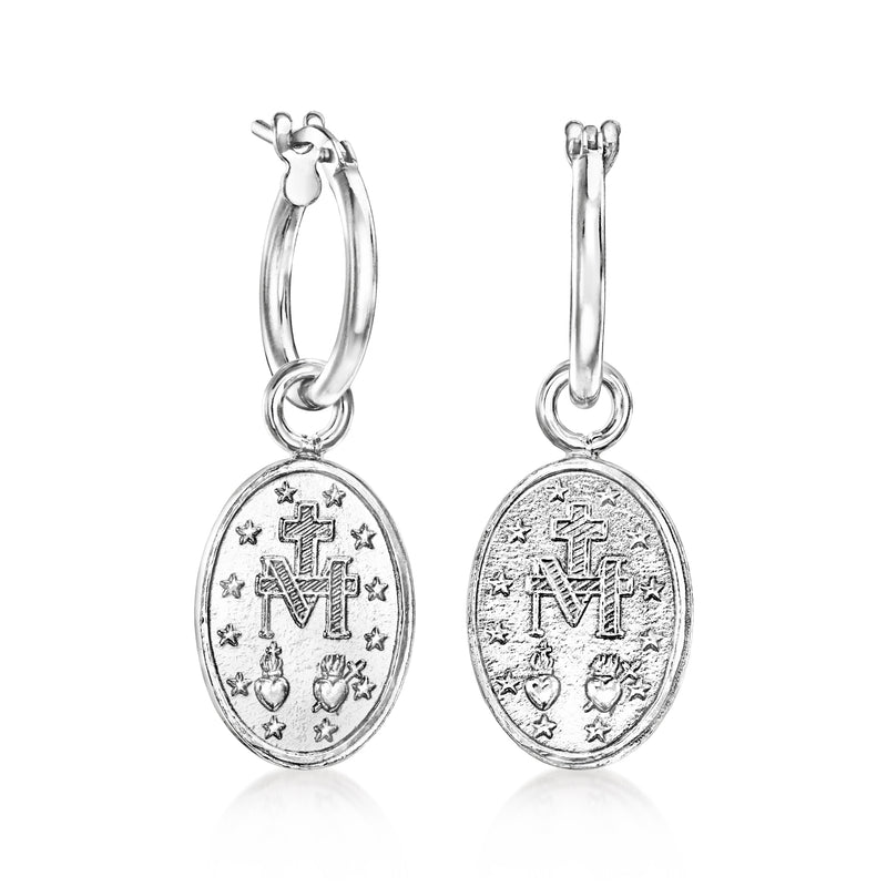 Sterling silver hoop earrings with oval medallion drops featuring cross and stars
