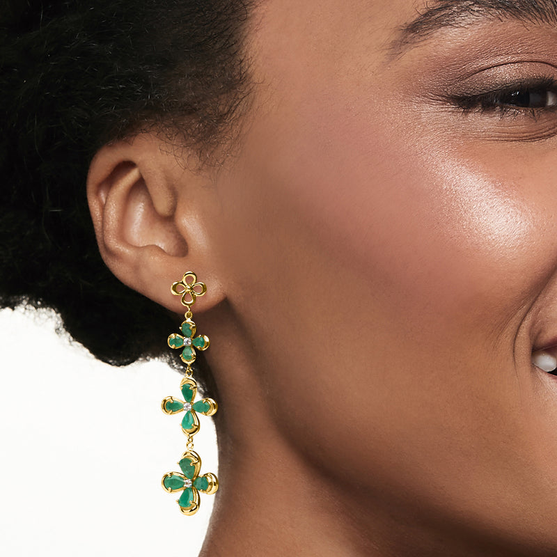 Gold drop earrings with emerald-green flower centers and three dangling floral drops