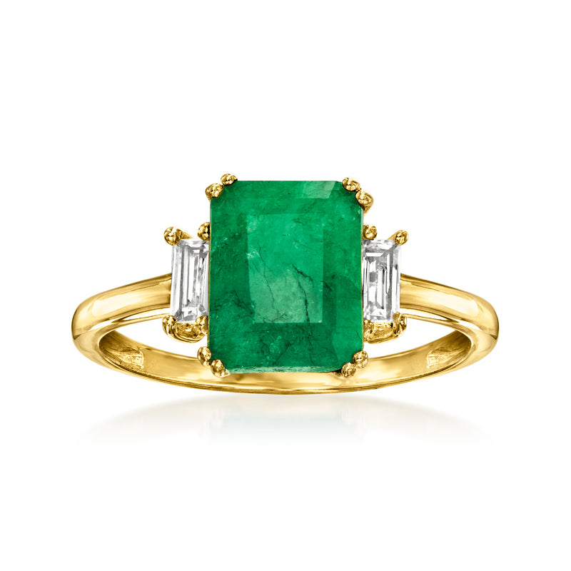 Gold ring with emerald-green emerald-cut center stone and white topaz baguette side stones.