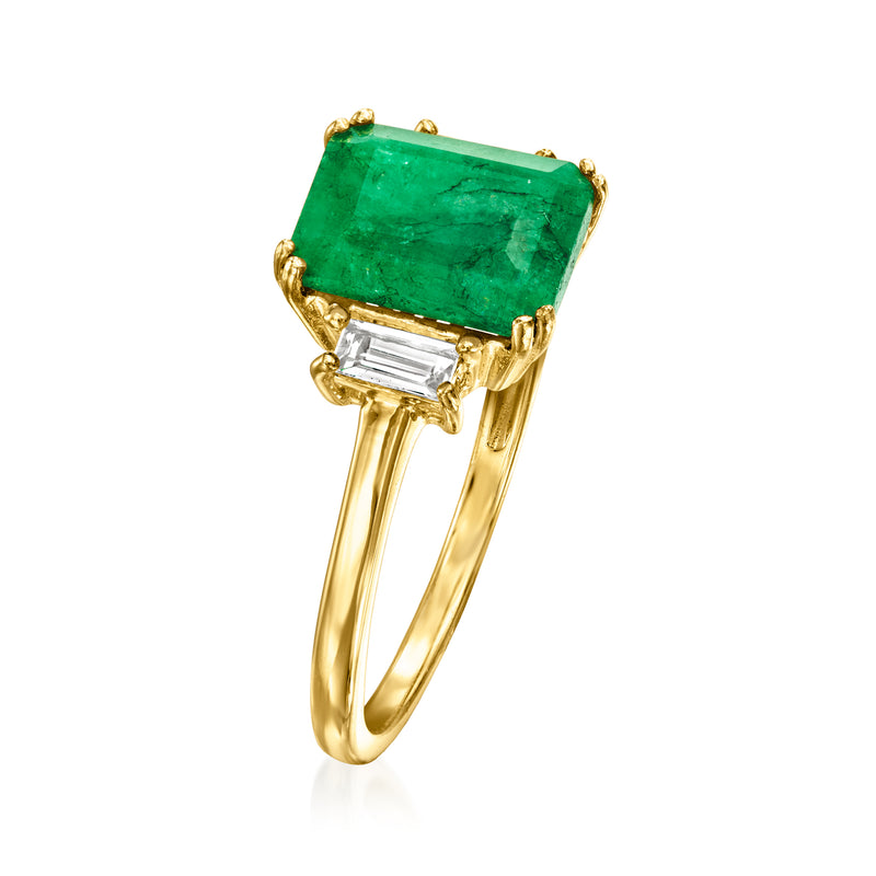 Gold ring with emerald-green emerald-cut center stone and baguette white topaz side stones.