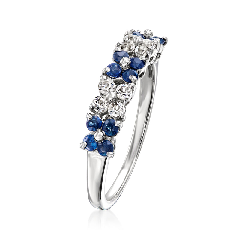 Sterling silver floral ring with blue sapphire and white gemstones, angled front view