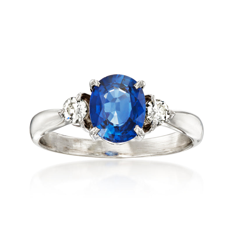 Platinum ring with oval blue sapphire center and round diamond side stones