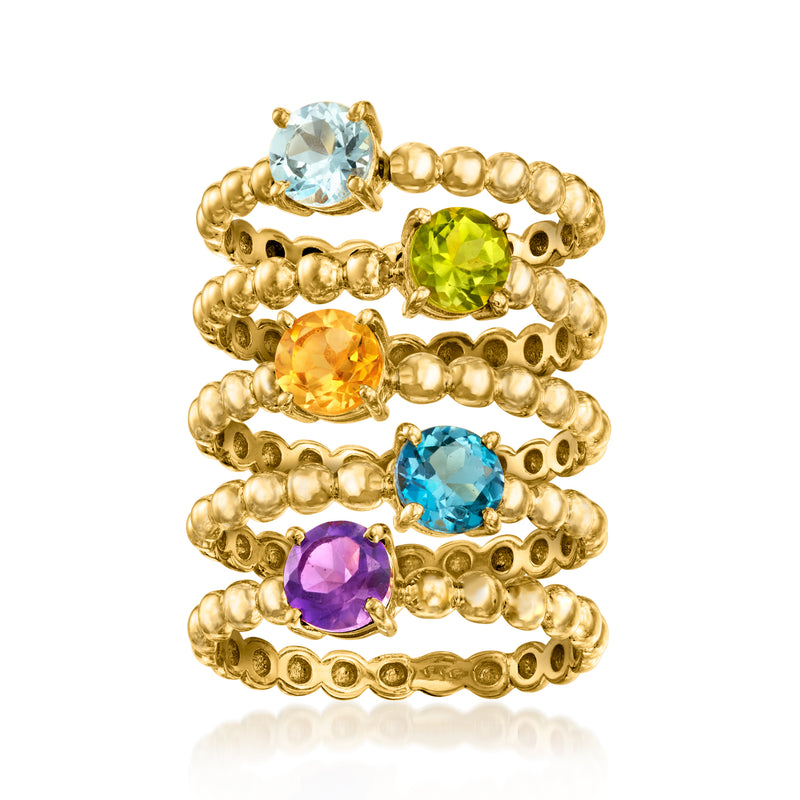 Five-ring jewelry set with oval blue, green, orange, and purple gemstones in gold-tone settings