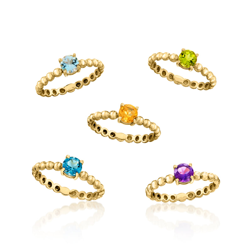 Gold-tone stackable rings with round blue, green, orange, and purple gemstones