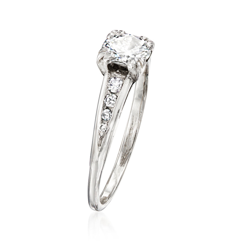 Vintage platinum diamond ring with cushion-cut center stone and pavé side stones