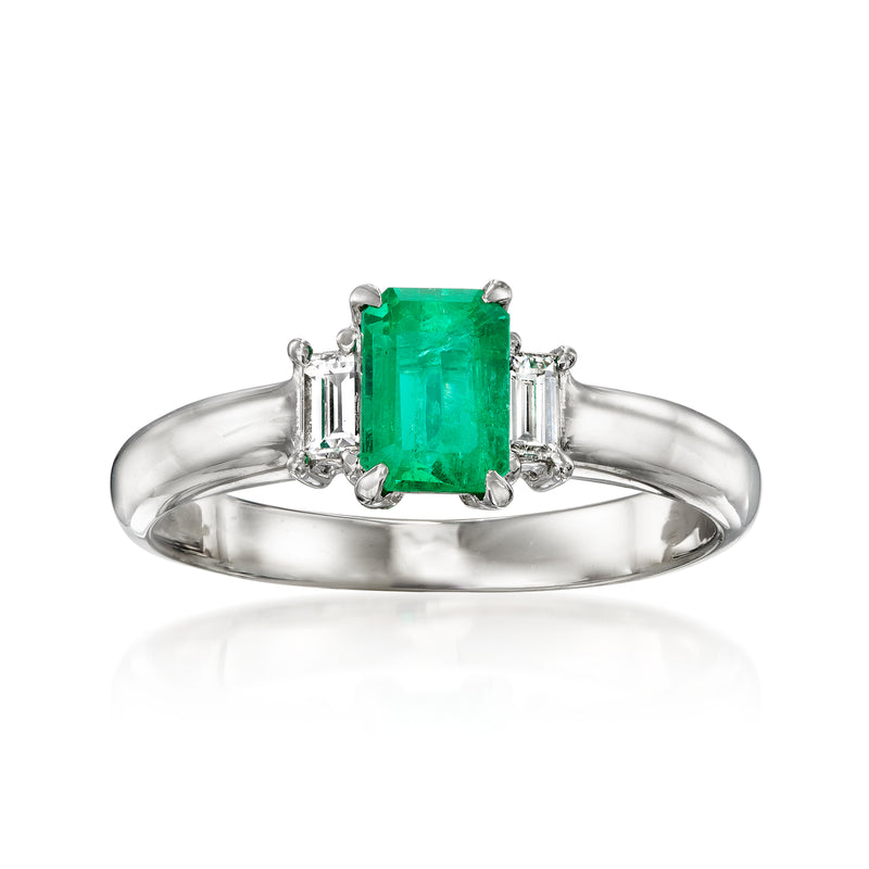Platinum vintage ring with emerald-cut green emerald center and diamond side stones