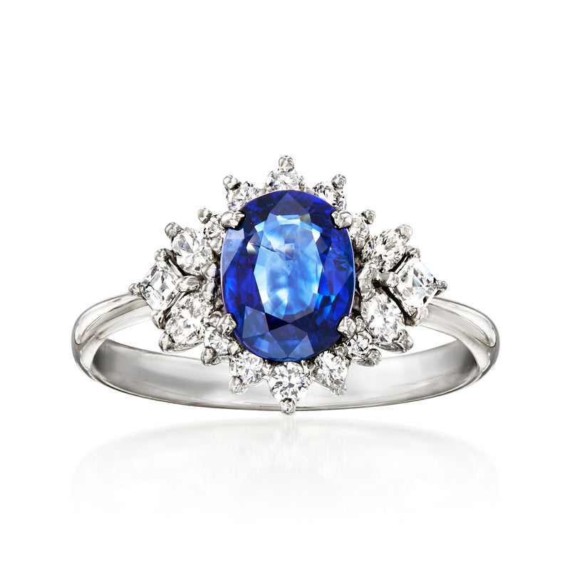 Platinum ring with blue oval sapphire center and diamond cluster halo