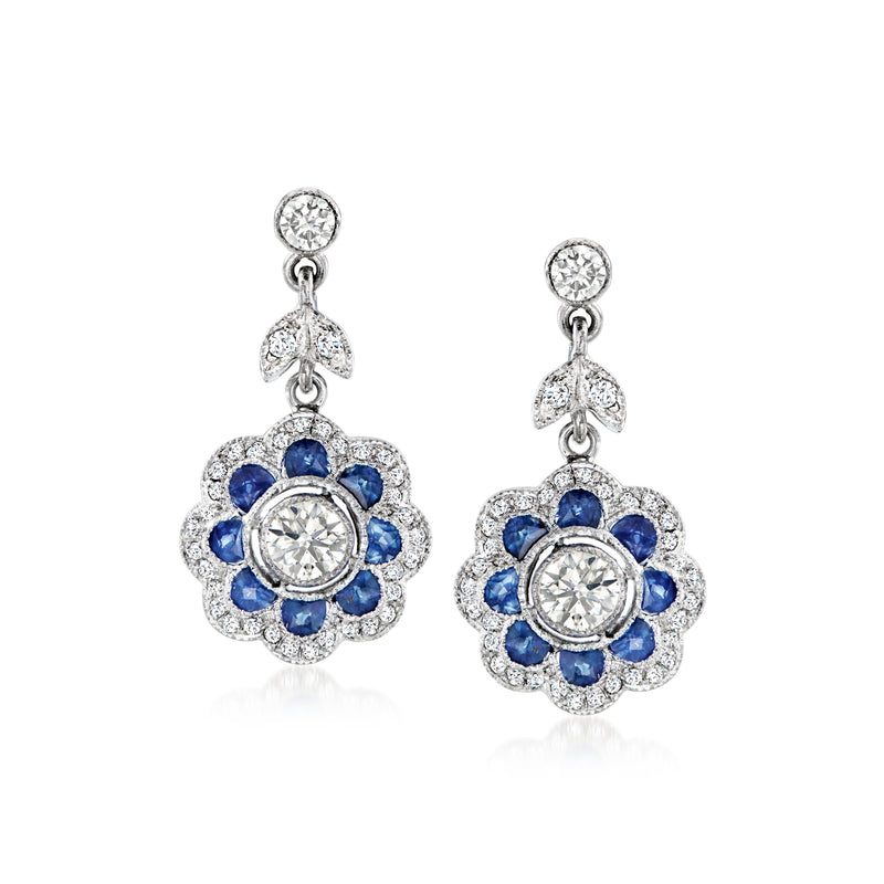 Sapphire and diamond floral drop earrings in white gold, circular center with blue petals