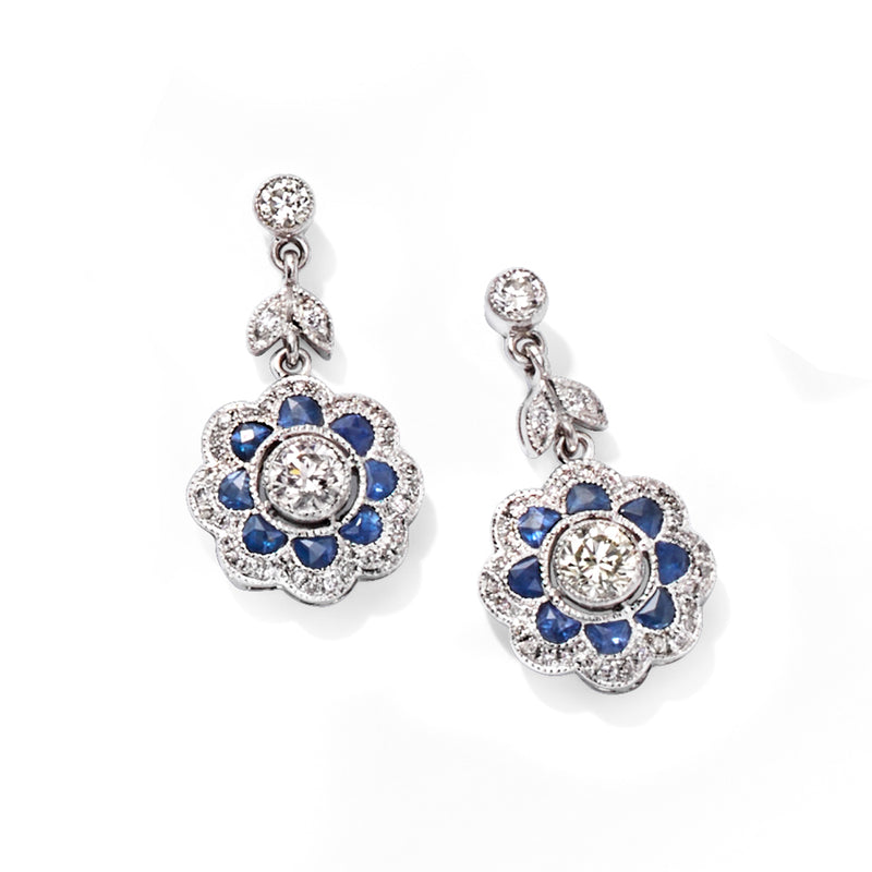 Diamond and sapphire drop earrings with round blue-floral motif and dangling chain, white gold