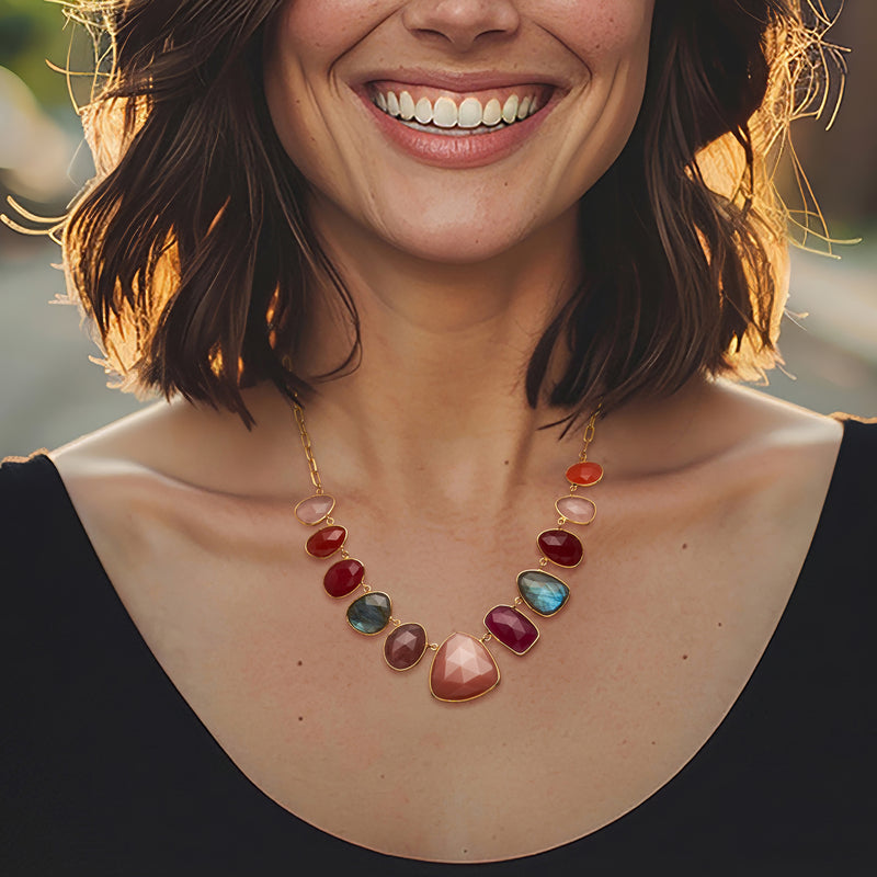 Multicolor gemstone bib necklace on model with gold chain and teardrop links