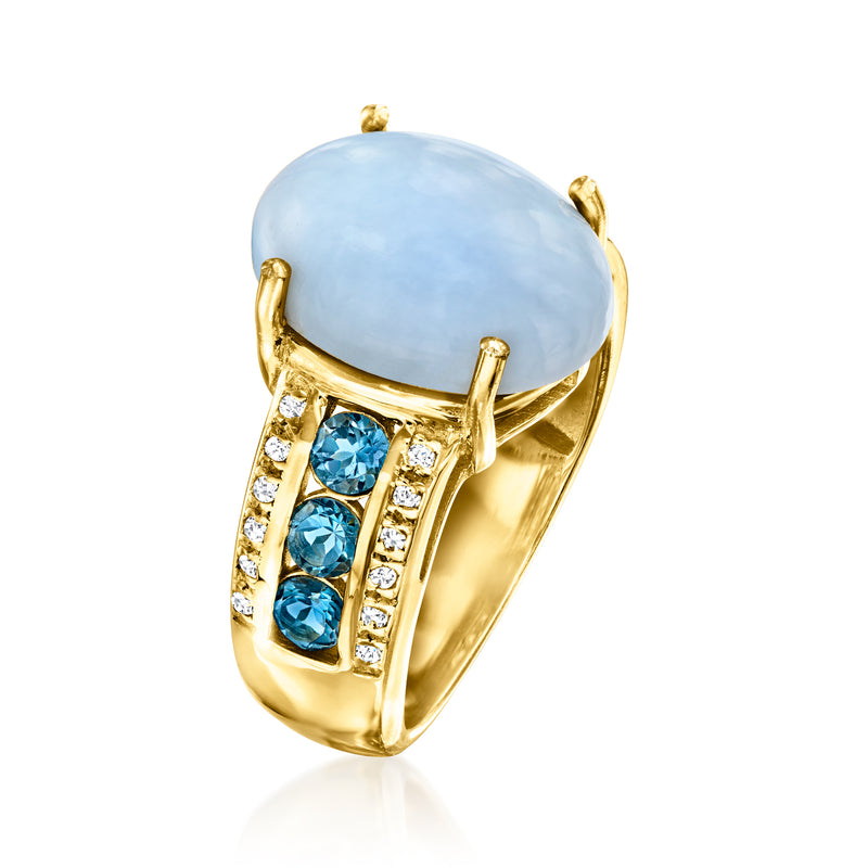 Gold-tone ring with oval light-blue centerpiece, blue gemstones, and small clear stones