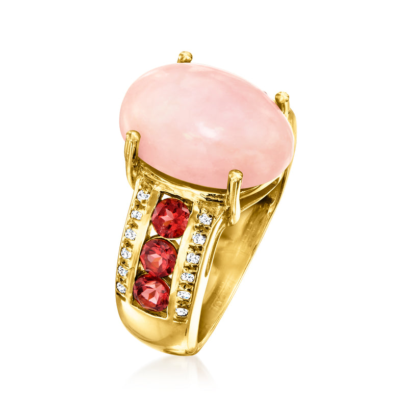 Gold ring with oval pink opal and red garnet stones in side bezel, clear accents