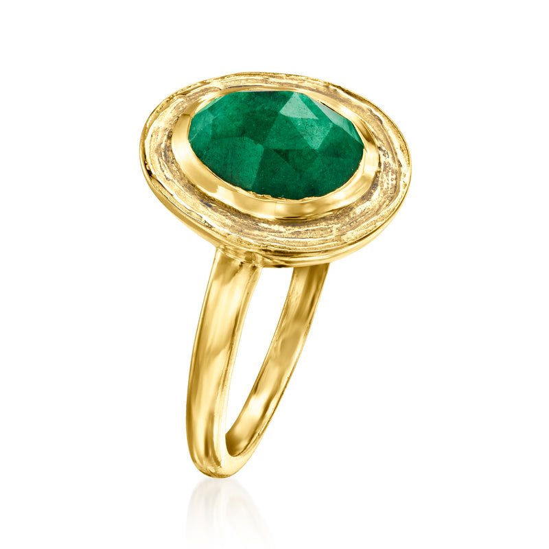 Gold oval emerald ring with bezel setting and scalloped halo surround
