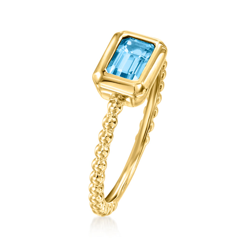 14kt yellow gold ring with rectangular blue topaz and twisted rope shank
