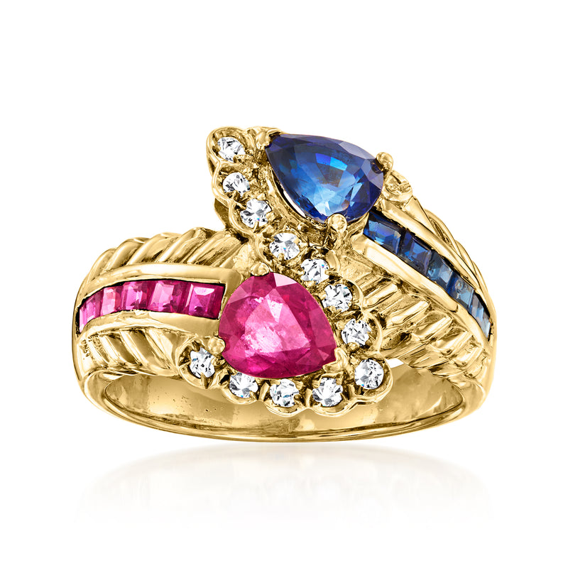 18kt yellow gold bypass ring with pink oval ruby, blue stone, and clear diamond accents
