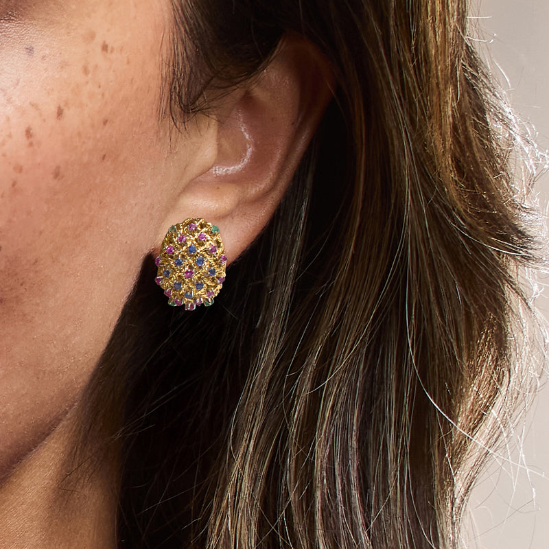 Multicolor gemstone cluster earrings in 18kt yellow gold, close-up on ear