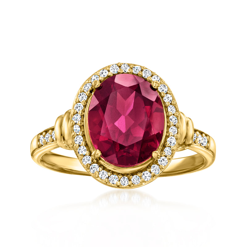 Gold over sterling ring with oval red rhodolite-style gemstone and white topaz halo