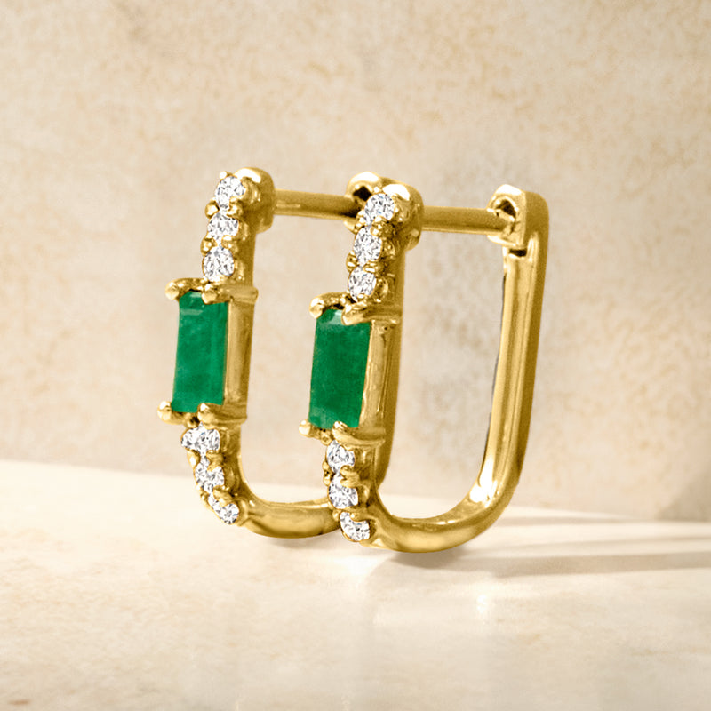 Yellow gold hoop link earrings with central green emerald and white diamond clusters