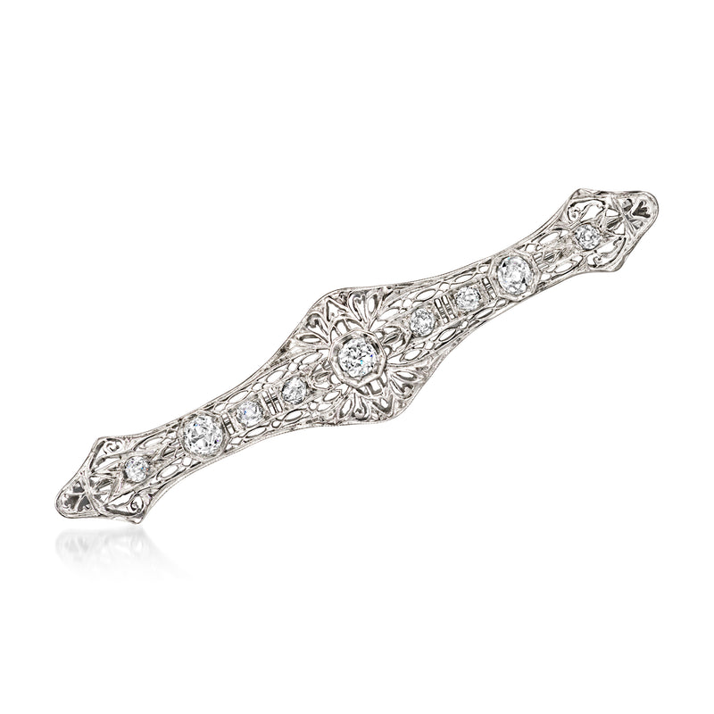 Diamond filigree pin in 18kt white gold with central round stone and pave accents
