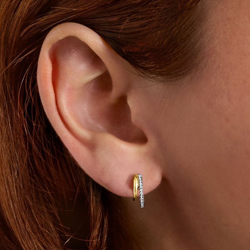 Two-tone sterling silver diamond double-hoop earrings on ear
