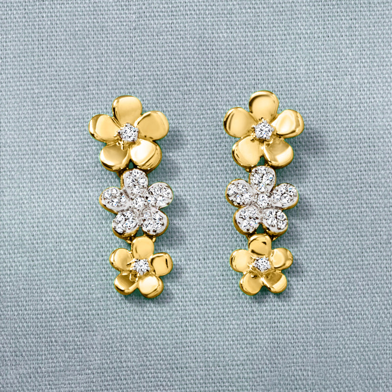 Gold-tone flower drop earrings with clustered clear stones, close-up front view.
