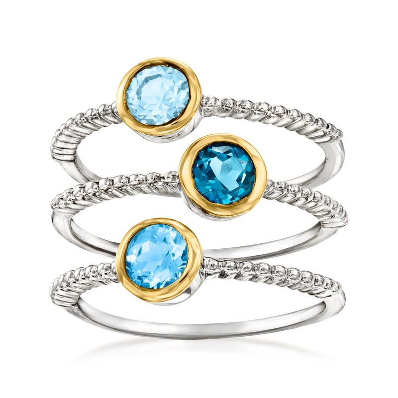 Three-ring set of sterling silver bands with round blue topaz and 18kt gold bezels