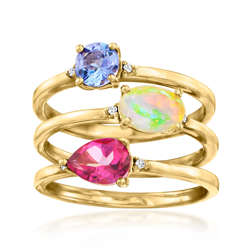 Gold-tone triple ring set with blue, opal-like, and pink oval stones and diamond accents