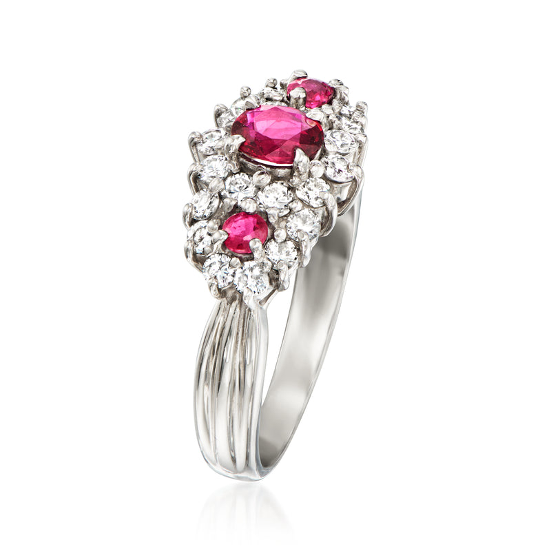 Vintage platinum ring with raised oval ruby centerpiece and clustered diamond surround