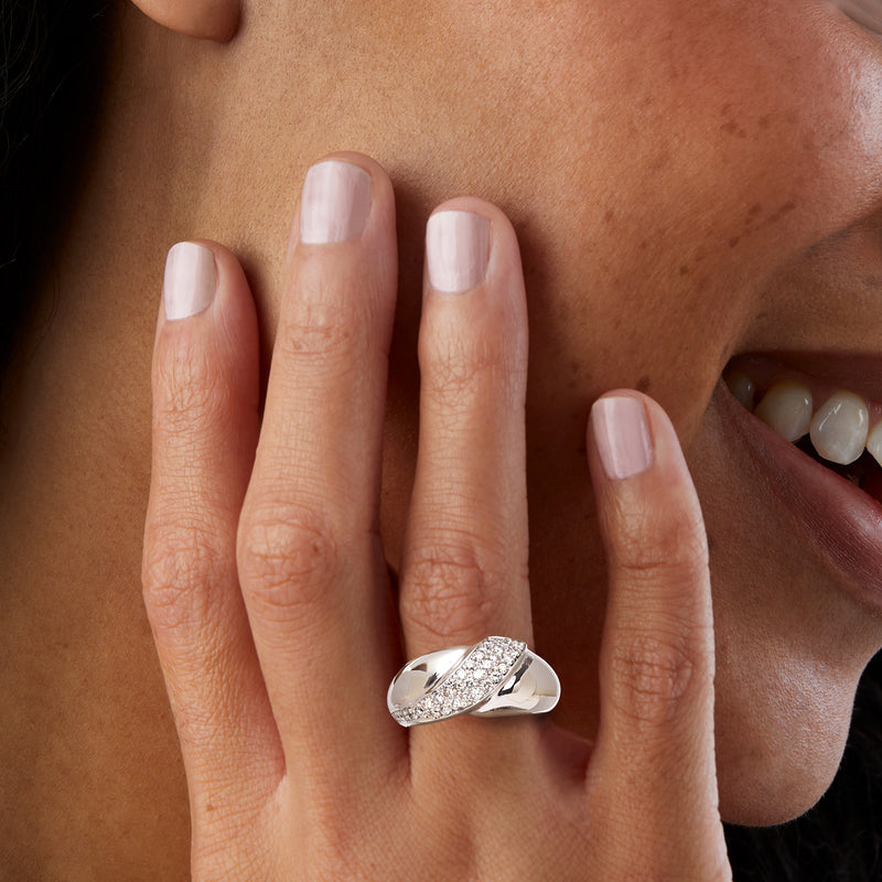 14kt white gold diamond stripe ring on finger with oval sparkling stones