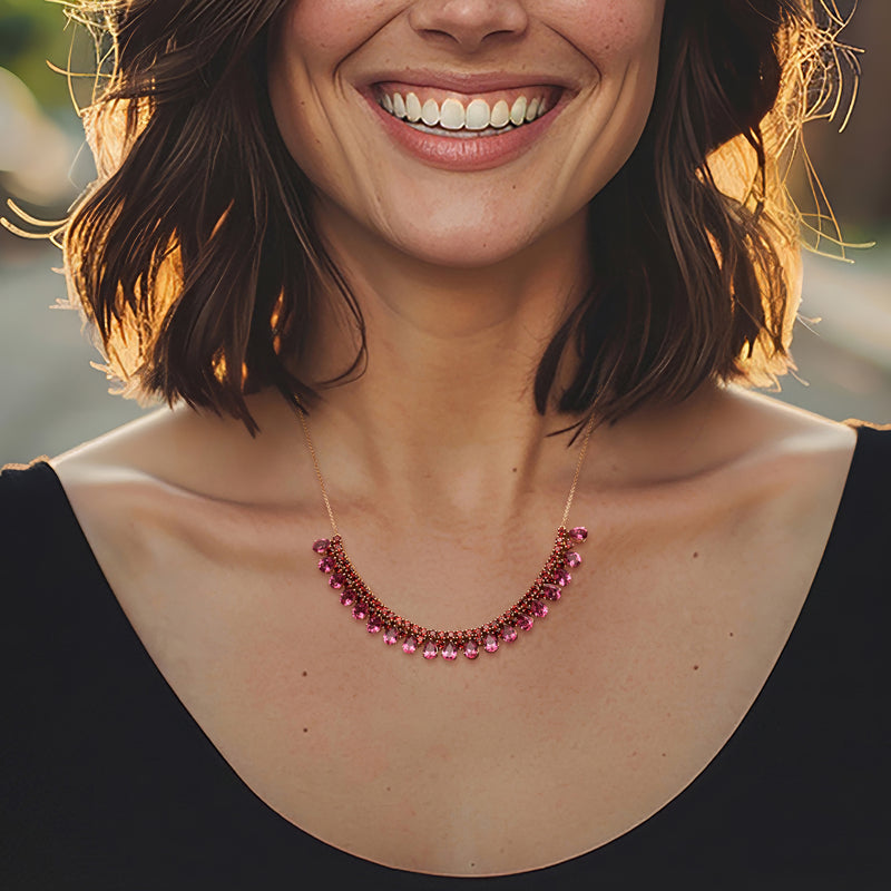 Pink gemstone necklace with gold over sterling silver chain, worn at neckline