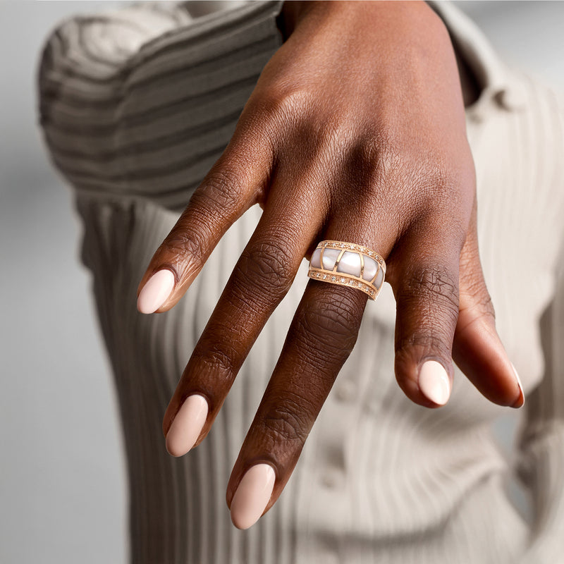 Rose gold mother-of-pearl diamond ring worn on hand