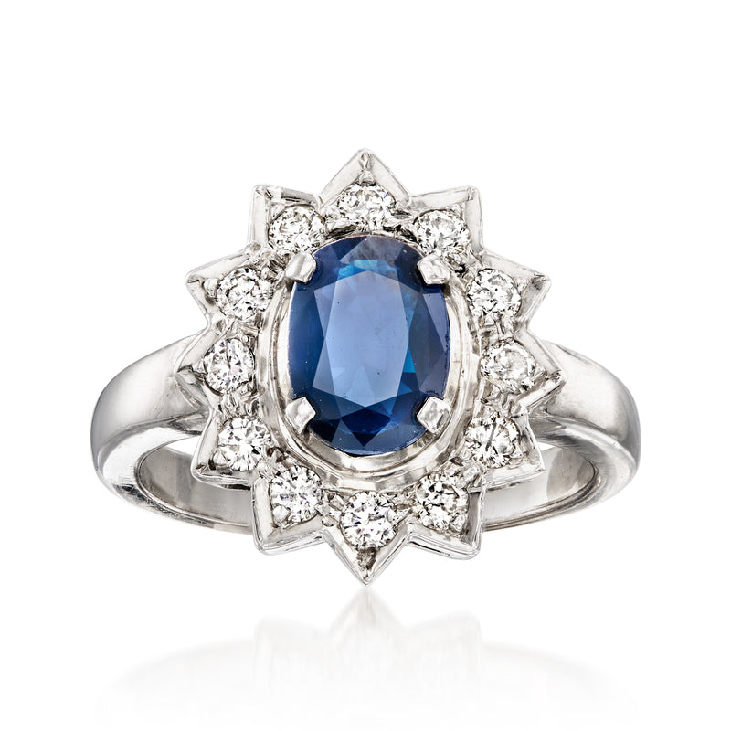 Vintage sapphire and diamond ring, oval blue sapphire with starburst halo, white gold band.