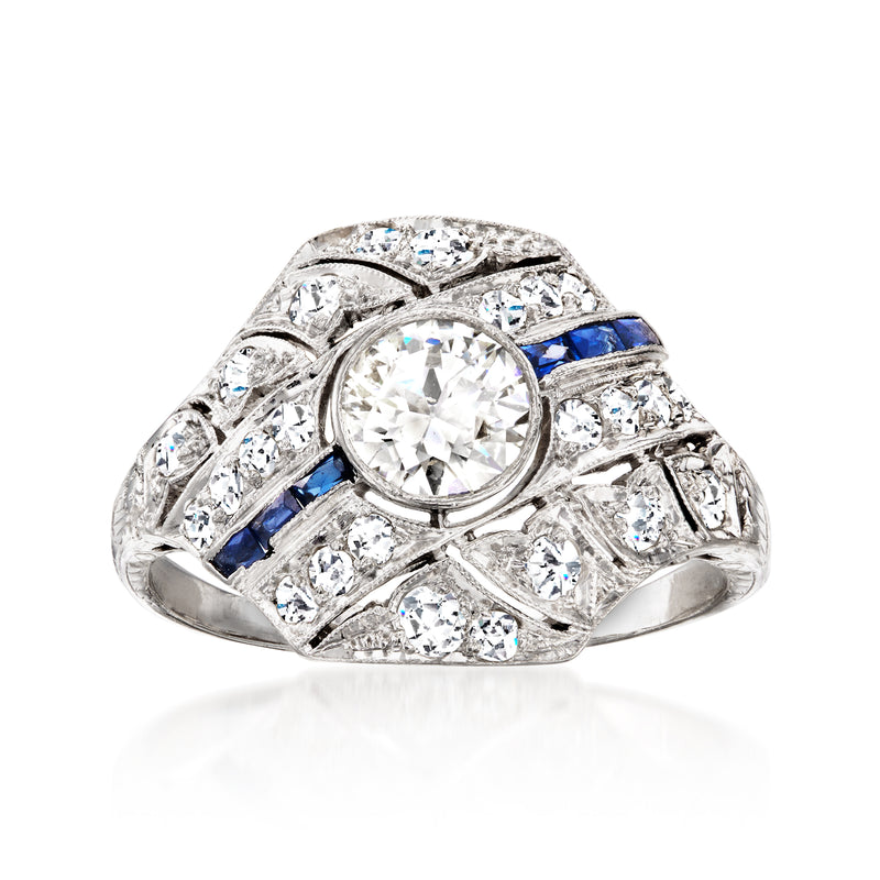 Platinum filigree ring with round center diamond, blue sapphire accents, and side diamonds